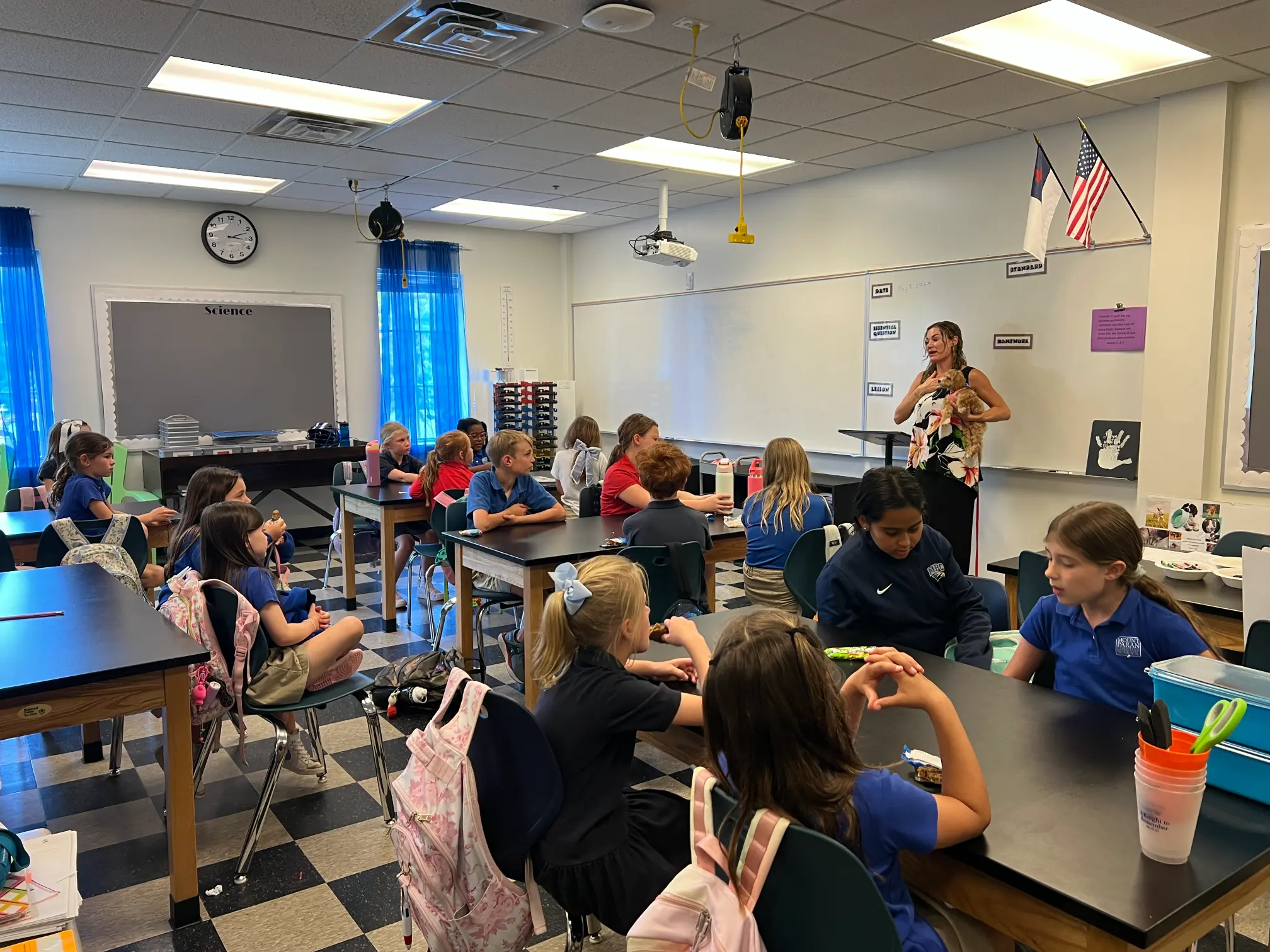 An educator leading a humane education lesson with students in a classroom.