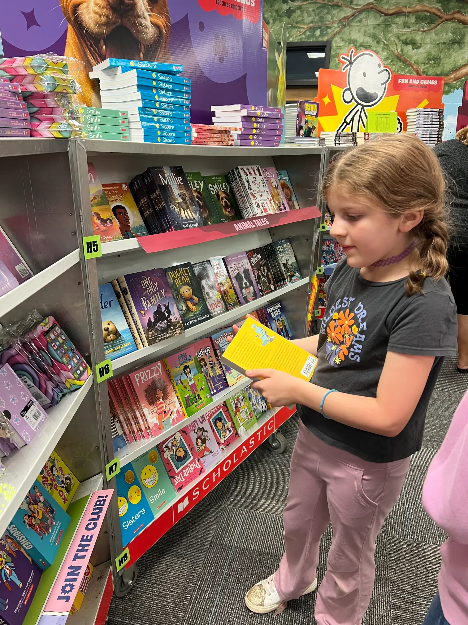 A child browsing animal-themed books in a bookstore.